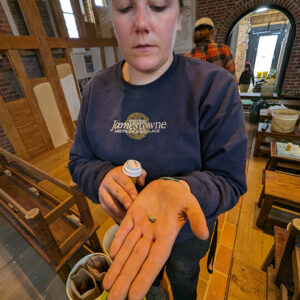 Archaeological Field Technician Hannah Barch holds a Nueva Cadiz bead found while screening soil from the Church Tower excavations.