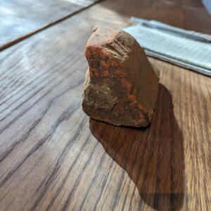 A shaped brick found during the Church Tower excavations. Mortar consistent with that used in the 1640s church construction can be seen still attached to the brick.