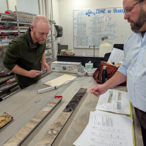 Director of Archaeology Sean Romo and University of Connecticut's Dr. David Leslie inspect a large section of charcoal in one of the Jamestown vibracore samples -- evidence of a forest fire that occurred more than 35,000 years ago.