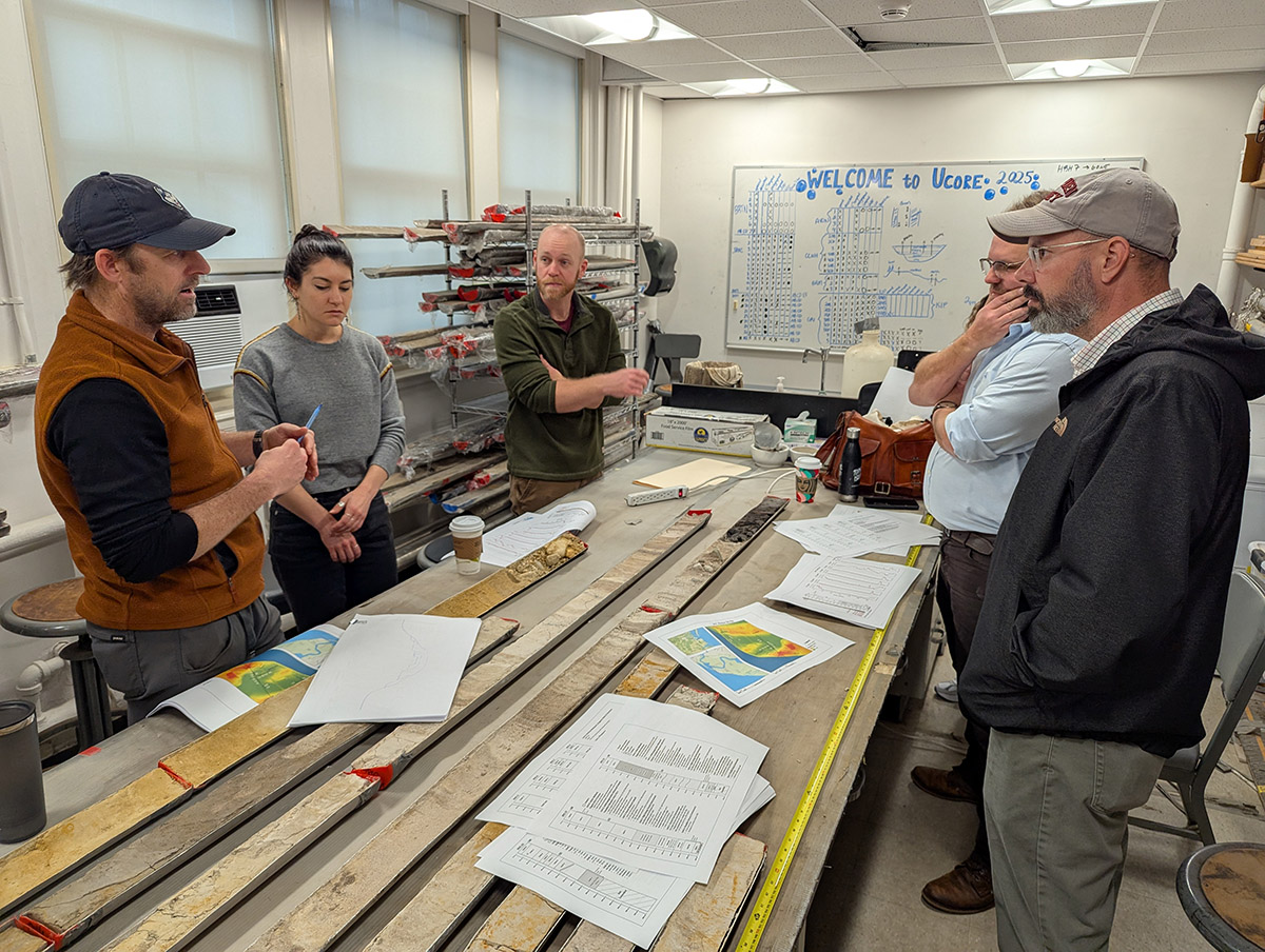 University of Connecticut's Dr. Will Ouimet, Associate Curator Emma Derry, Director of Archaeology Sean Romo, University of Connecticut's Cassie Aimetti (mostly hidden) and Dr. David Leslie, and Director of Collections and Conservation Michael Lavin discuss the results of the latest batch of vibracore samples from Jamestown.