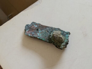 One of the pieces of copper alloy book hardware that Senior Conservator Dan Gamble is conserving