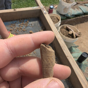A partial pipe stem found by Assistant Conservator Jo Hoppe on one of the staff dig days.