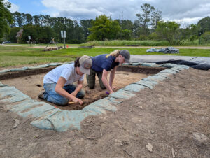 Archaeological Field Technician Katie Griffith (right) works with a Field School student at the barracks site.