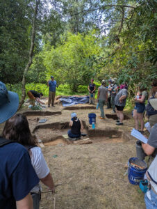 Dr. David Gadsby explains the findings of his team's ongoing excavations at the Travis Estate to field school students and staff.