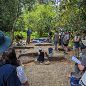 Dr. David Gadsby explains the findings of his team's ongoing excavations at the Travis Estate to field school students and staff.