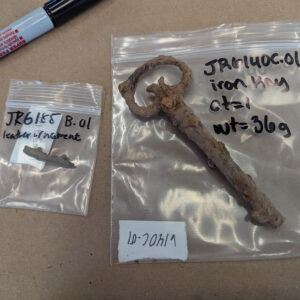 A leather ornament and iron key found in the excavations south of the Archaearium