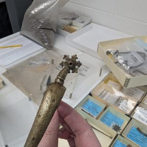 A snowflake-shaped rowel that is part of a copper alloy spur