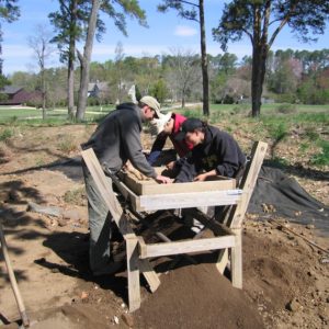 Archaeologists screen for artifacts