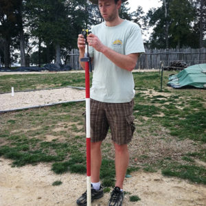 man standing with a stadia rod