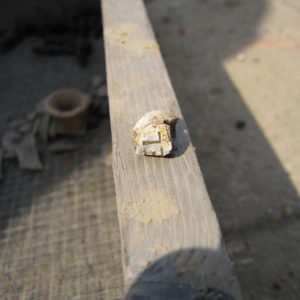 Pipe bowl fragment sitting on the side of a screen