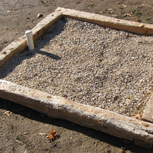 Wood beams aligned in a square and filled with gravel