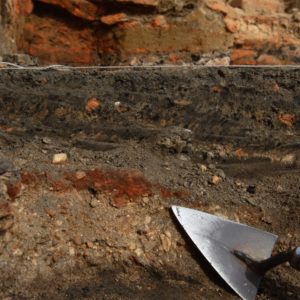 Trowel pointing to ash layers