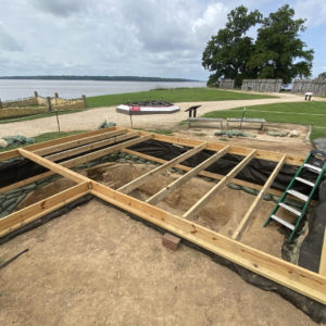 large excavation unit covered with a wooden platform