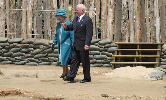 Suited man walking with Queen