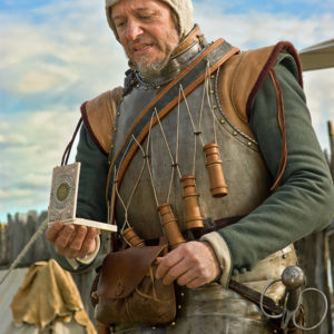 Man in historical armor reading a reproduction pocket sundial