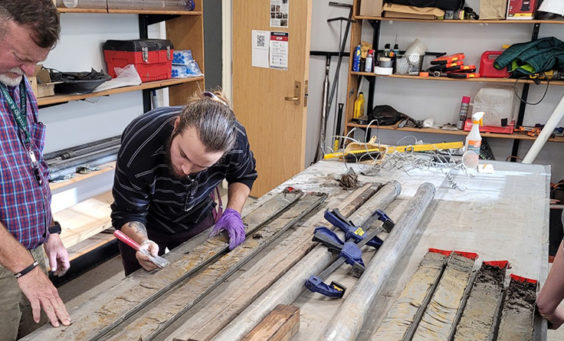 Director of Archaeology David Givens, Preston Senderoff, and graduate student Stephanie Scialo inspect the sediment in the core sample.