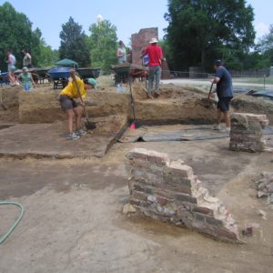 A group of students excavating with shovels