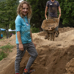 A camper and archaeologist Josh Barber at the pile of already-screened soil.