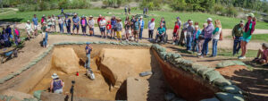 Staff Archaeologist Natalie Reid explains the excavations of the 1608 ditch and 1610s well during an archaeology tour.