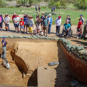 Staff Archaeologist Natalie Reid explains the excavations of the 1608 ditch and 1610s well during an archaeology tour.