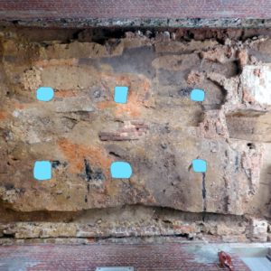 Aerial view of marked postholes in dirt floor