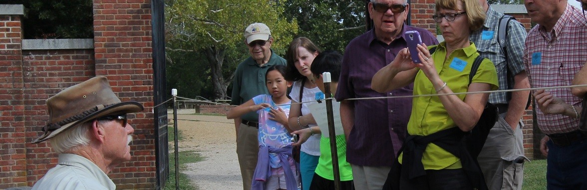 Archaeologist speaks to a group of visitors