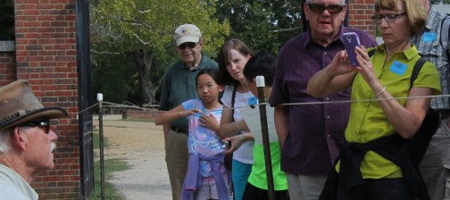 Archaeologist speaks to a group of visitors